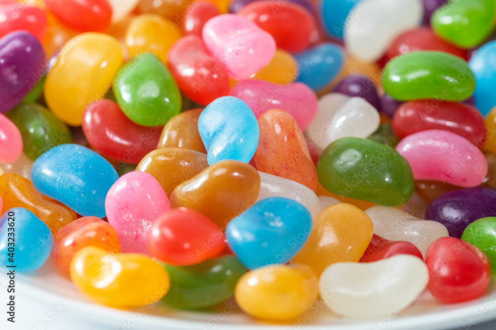 A plate of colourful Jelly Beans on a white background A plate of colourful Jelly Beans on a white background