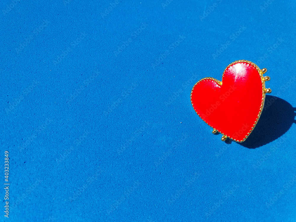 Fototapeta premium red heart on blue background. Valentine's Day background. Red heart on blue background. Valentines day concept. Flat lay. Copy space 