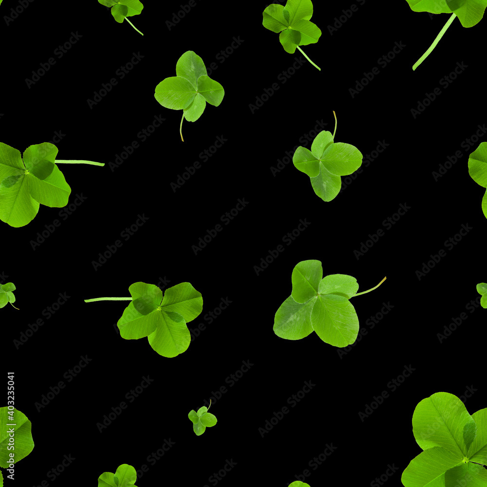 Seamless pattern with green four-leaf clover leaves on a black background Seamless pattern with green four-leaf clover leaves on a black background