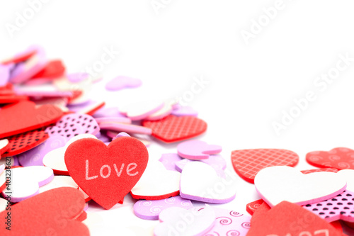 Valentine's Day background. White and red hearts with word love on white background. Valentines day concept. Flat lay, top view, copy space