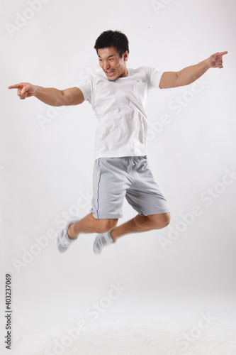 A young man jumping in casual clothes