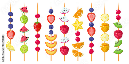 Fruit canapes mix on wooden skewers. Strawberries, blueberries, raspberries, watermelon, kiwi, banana, tangerine.