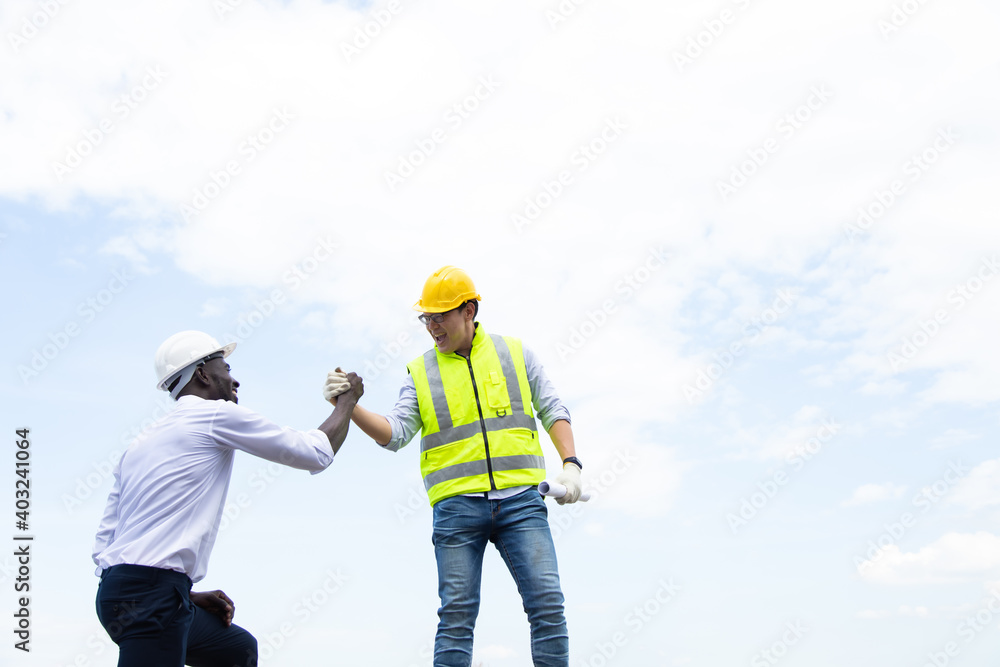 Architect and engineer construction worker shaking hands on construction site. Architect and engineer construction worker shaking hands on construction site.