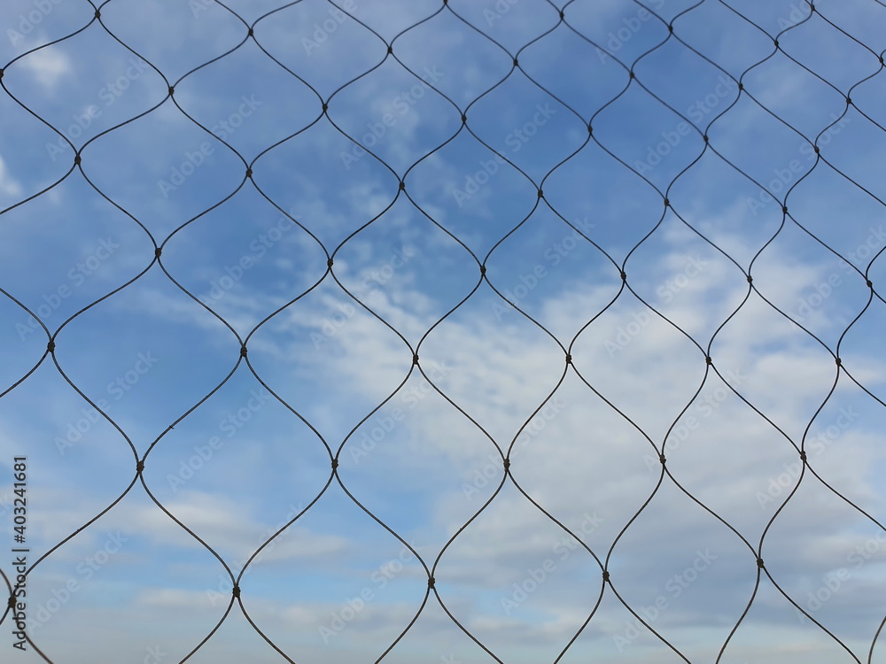 Plastic nets are used to prevent items from falling for high-class residents. Looking through the net, we can see the sky with white clouds scattered.
Plastic nets are used to prevent items from falling for high-class residents. Looking through the net, we can see the sky with white clouds scattered.