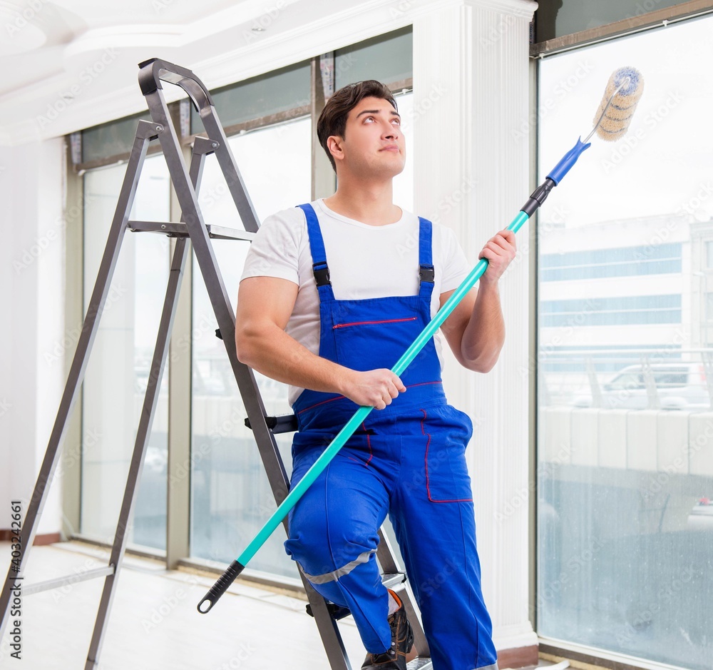 Painter repairman working at construction site Painter repairman working at construction site