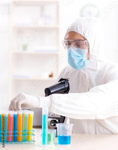 Young chemist student working in lab on chemicals