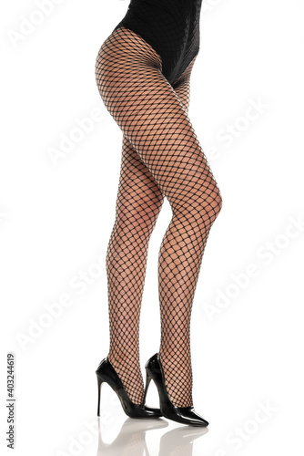 pretty female legs in fishnet stockings and black high heels photo