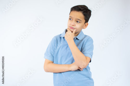 young caucasian boy thinking over white background