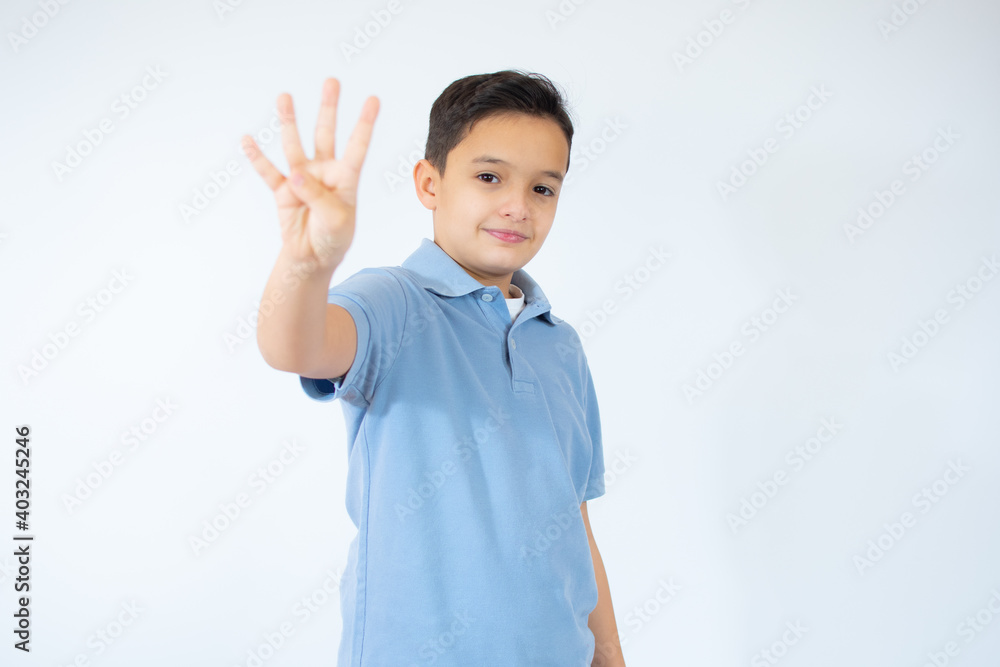 Beautiful kid boy wearing blue T-shirt standing over isolated white background showing and pointing up with fingers number four while smiling confident and happy Beautiful kid boy wearing blue T-shirt standing over isolated white background showing and pointing up with fingers number four while smiling confident and happy