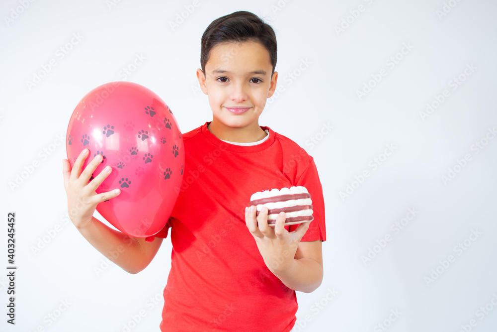 Young boy celebrating birthday with cake thinking attitude and sober expression looking self confident Young boy celebrating birthday with cake thinking attitude and sober expression looking self confident