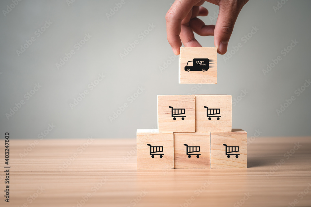 The wooden cubes are stacked together with a cart icon and a pickup truck at the top. Delivery is the growth of sales with children. Trade and order online in bulk. The wooden cubes are stacked together with a cart icon and a pickup truck at the top. Delivery is the growth of sales with children. Trade and order online in bulk.