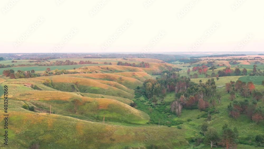 flight over a valley with beautiful large hills at sunset
flight over a valley with beautiful large hills at sunset