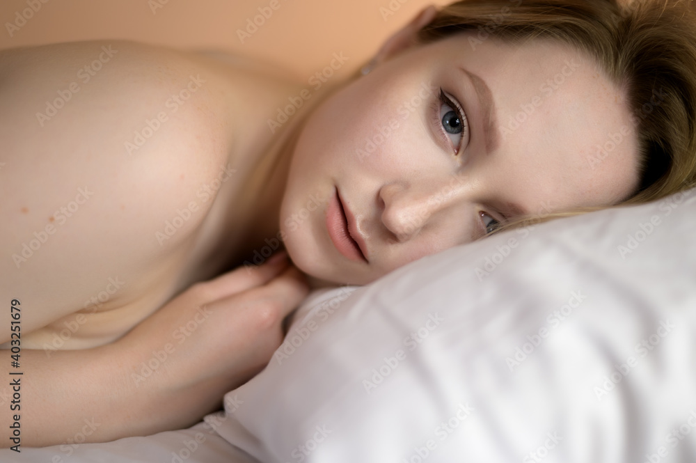 Closeup portrait of a beautiful young lady lying on the bed. Closeup portrait of a beautiful young lady lying on the bed.