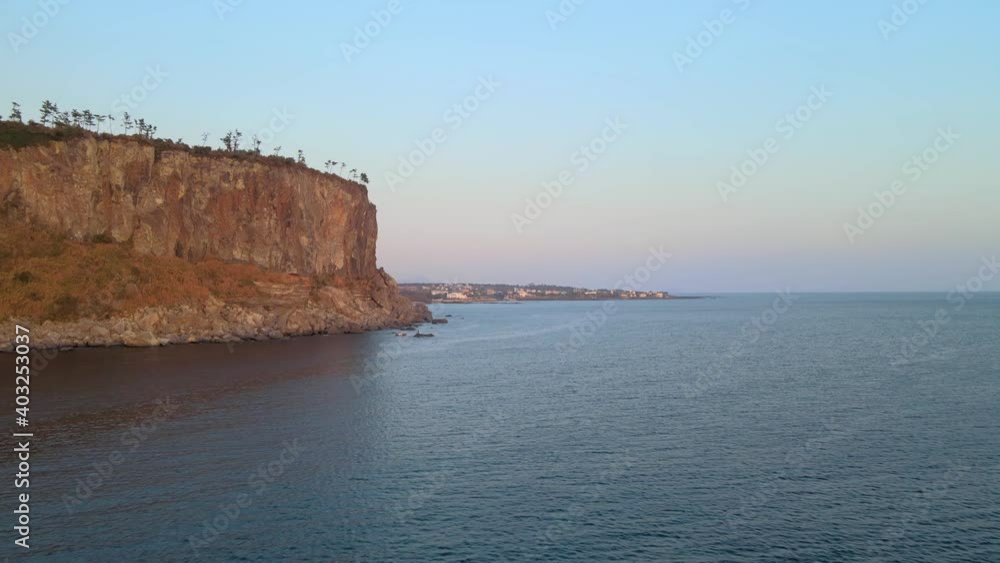 4K Passing-by Low-Flight Aerial View of Bagsugijeong Cliff During Sunset, Jeju. 4K Passing-by Low-Flight Aerial View of Bagsugijeong Cliff During Sunset, Jeju.