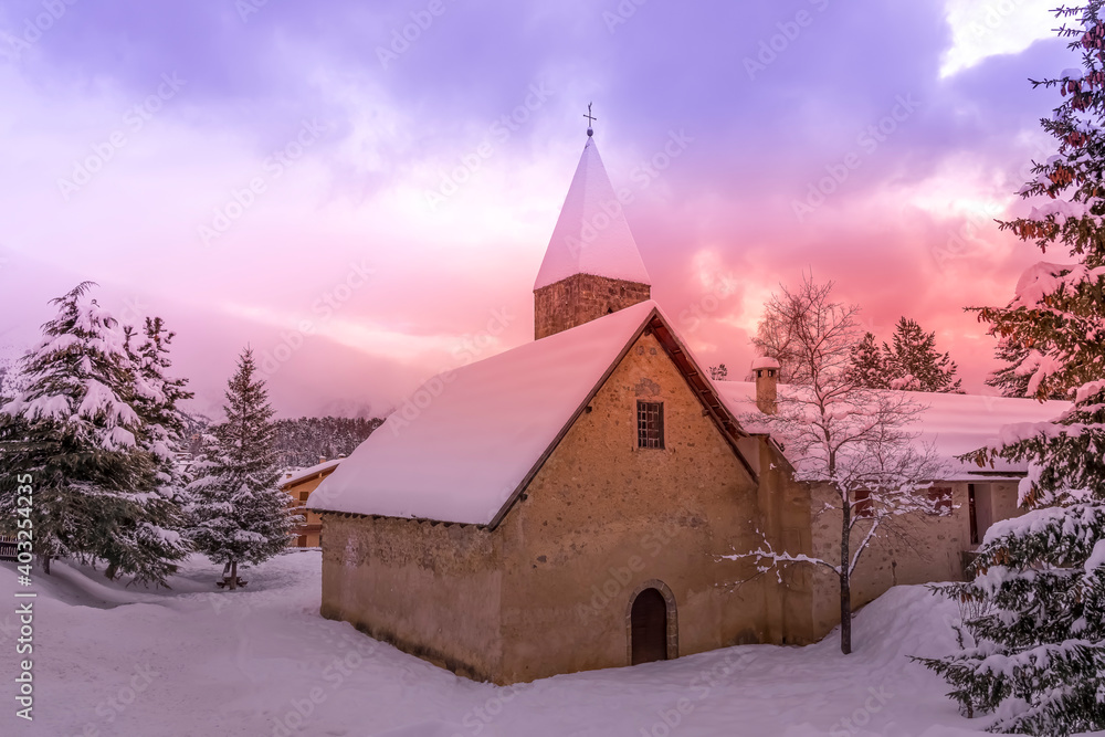 Mountain town Auron in winter. Evening pink sunset. Popular ski resort in Alps Maritime, France. High quality photo