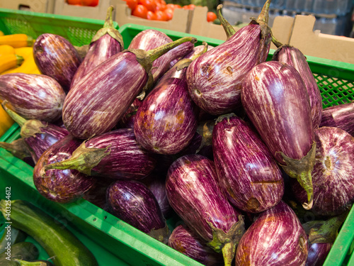 Wallpaper Mural Striped graffiti eggplant in a box on the market. A lot of purple vegetables with white longitudinal stripes. Torontodigital.ca