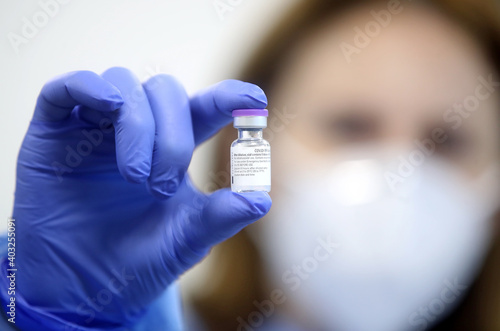 Medical worker holds needle with vaccine for coronavirus, COVID-19