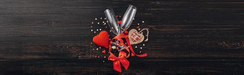 concept for valentine's day. gala dinner for two with two glasses of champagne. background with the attributes of the celebration of Valentine's Day. dominant red color. studio shot, top view.