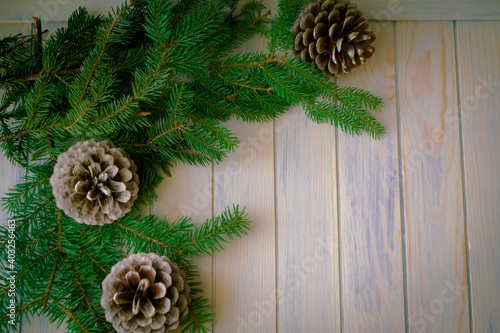 Blue wooden christmas background with fir branches, pin cones. Top view, copy space. photo