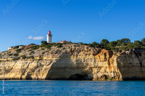 view of the Alfanzina lighthouse on the beautiful Algarve coast of Portugal © makasana photo