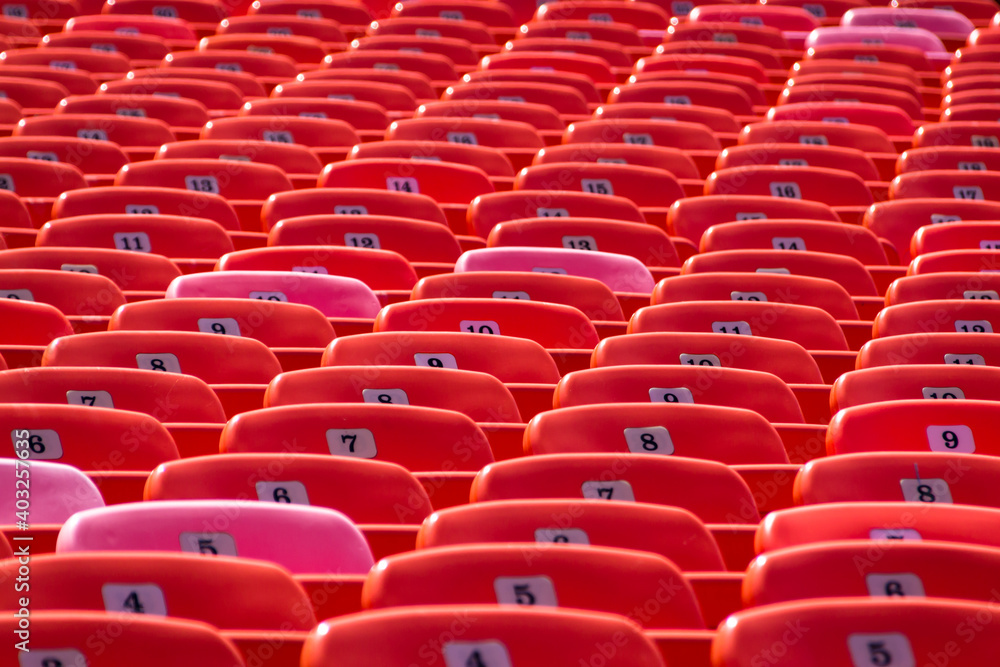 Fototapeta premium Abstract Background of Red Seats in Empty Stadium. Concept of Emptiness and Lock Down.