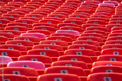 Abstract Background of Red Seats in Empty Stadium. Concept of Emptiness and Lock Down.