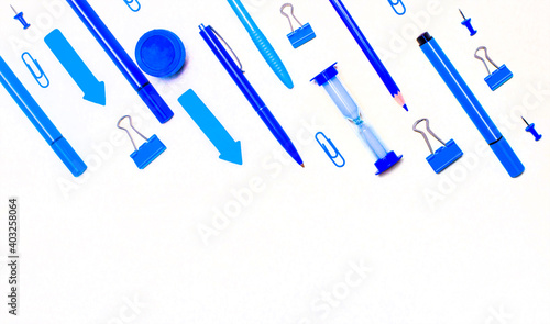 School supplies in blue and light blue on a light background with copy space. Flat lay