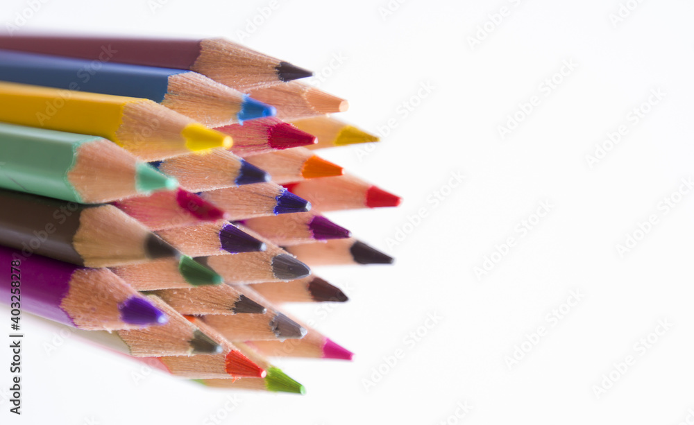 Assortment of coloured pencils on white background