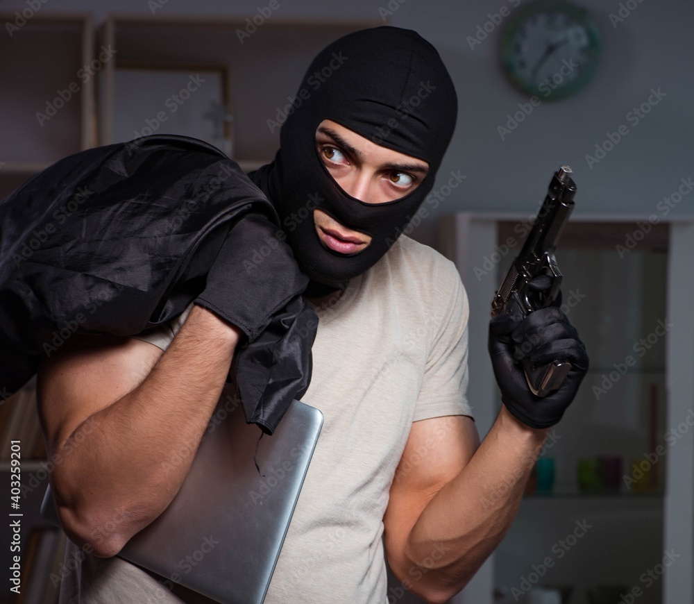 Burglar wearing balaclava mask at crime scene Burglar wearing balaclava mask at crime scene