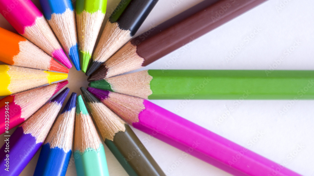 Colored pencils placed in circles on a white background. Colored pencils placed in circles on a white background.