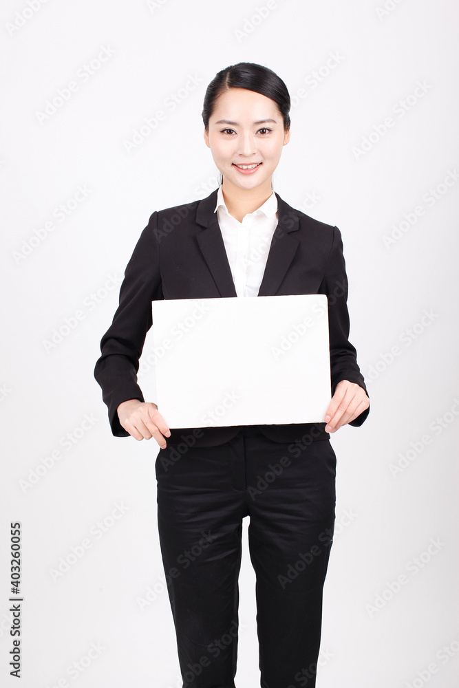 A business woman holding a white board A business woman holding a white board