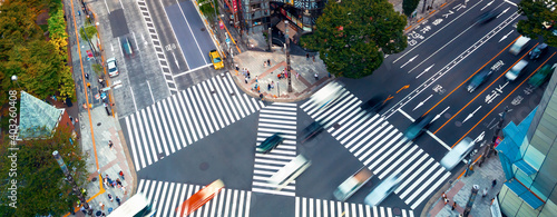 Traffic and people cross a busy intersection in Ginza, Tokyo