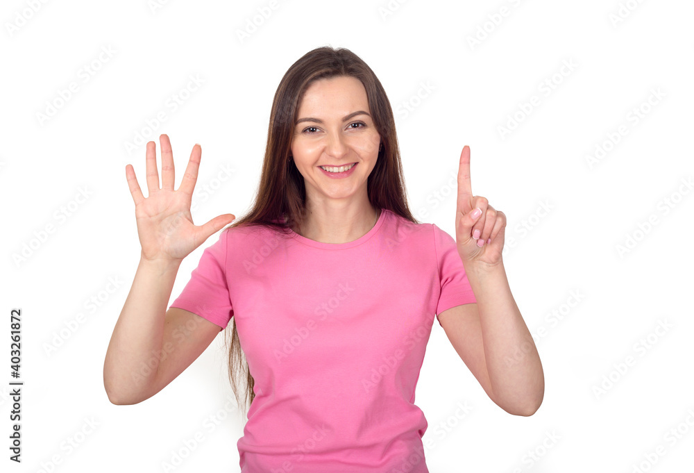 Young woman in a pink sweater shows 6 fingers as the number six. Young woman in a pink sweater shows 6 fingers as the number six.