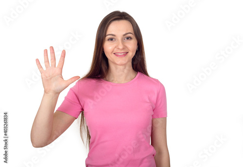Brunette woman in a pink sweater shows her palm, 5 fingers as the number five. © A Stock Studio
