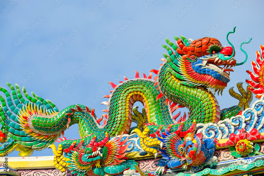 Colorful mosaic dragon statue on the roof of a Chinese temple Colorful mosaic dragon statue on the roof of a Chinese temple