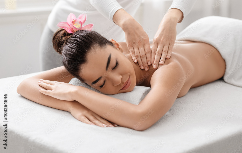 Spa Massage. Young Asian Woman Relaxing While Professional Therapist Massaging Her Shoulders Spa Massage. Young Asian Woman Relaxing While Professional Therapist Massaging Her Shoulders