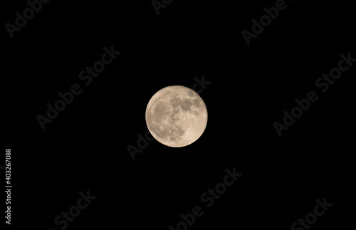 full moon in the night . Moon is an astronomical body that orbits planet Earth, and is Earth's only permanent natural satellite