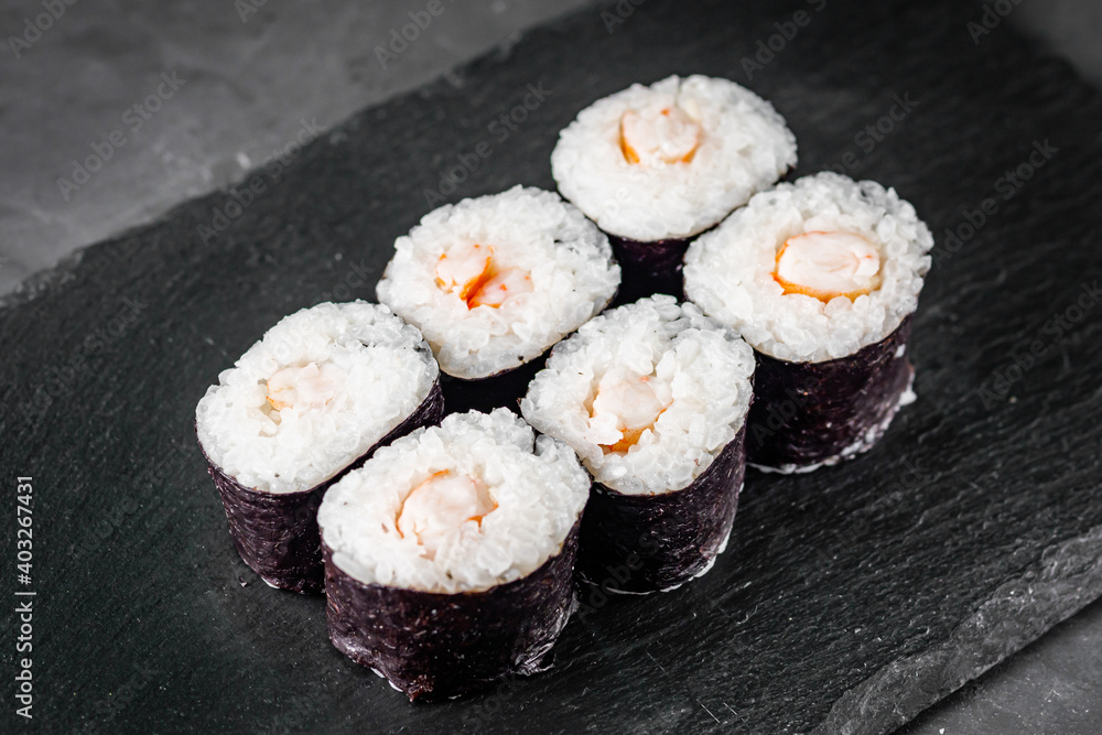 appetizing sushi shrimp maki roll on a black stone plate appetizing sushi shrimp maki roll on a black stone plate
