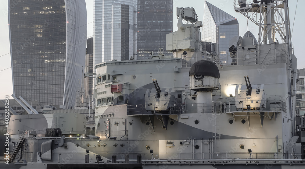 London, England - Apr 20, 2019 : Close-up of The retired Royal Navy light military cruiser or HMS Belfast which saw battle in WWII and is now a museum ship moored on the River Thames. London, England - Apr 20, 2019 : Close-up of The retired Royal Navy light military cruiser or HMS Belfast which saw battle in WWII and is now a museum ship moored on the River Thames.