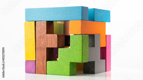 Bilde på lerret Cube made of multicolored wooden figures on a white background