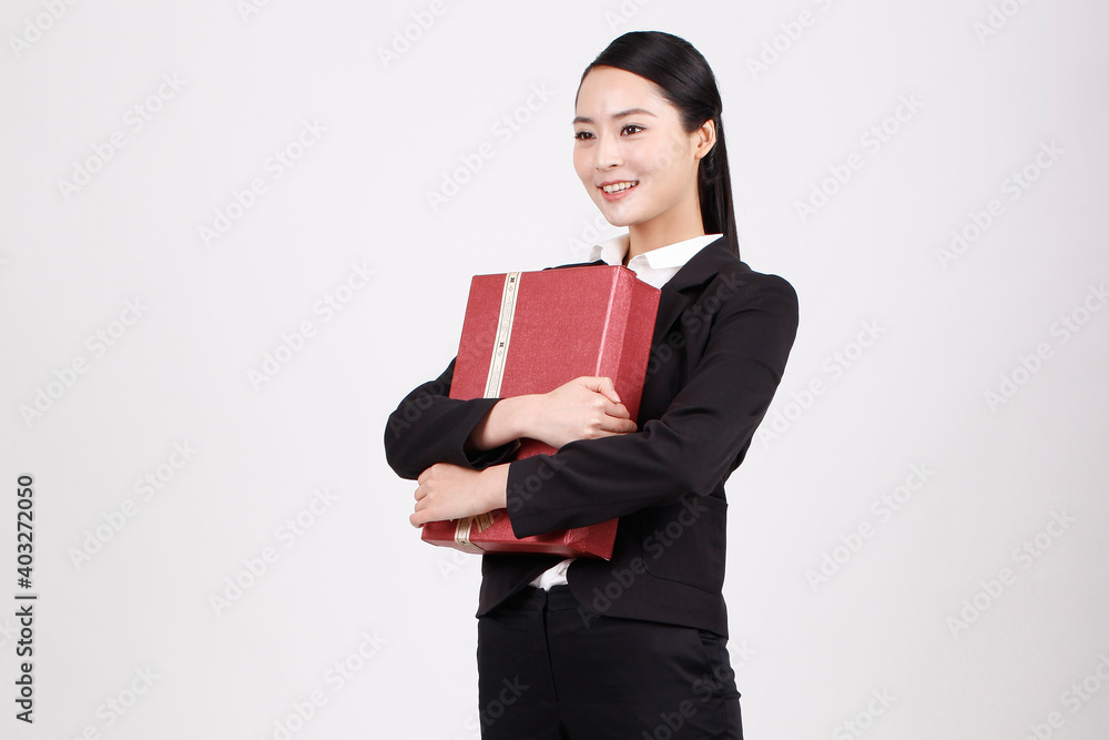 A business woman carrying a gift box A business woman carrying a gift box