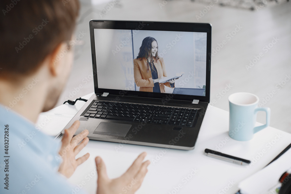 Man sitting in living room at home. Guy enjoying studying using laptop and headset. Man sitting in living room at home. Guy enjoying studying using laptop and headset.