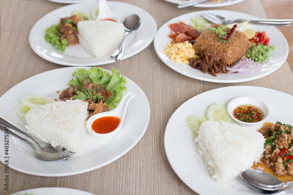 Many Thai food on white plates ready for eating Many Thai food on white plates ready for eating