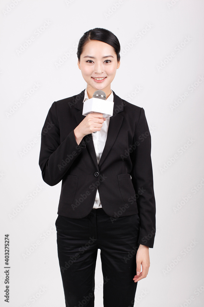 A business woman holding the microphone to interview A business woman holding the microphone to interview