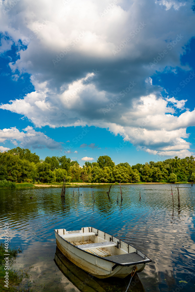 Small boat on the calm lake Small boat on the calm lake
