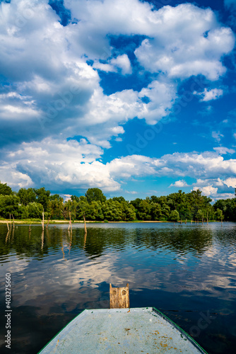 Small boat on the calm lake photo