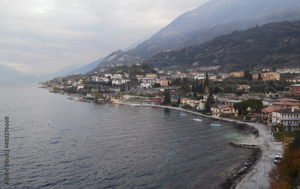 Top view of the coastline of Lake Garda, mountains and the town of Malcesine.
