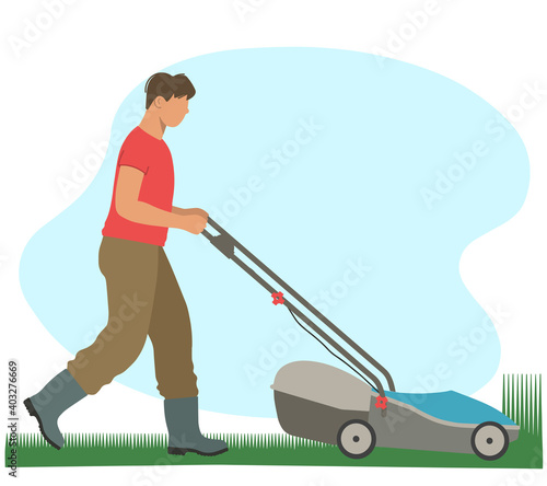 Gardening. Male gardener mows the grass with a lawn mower.