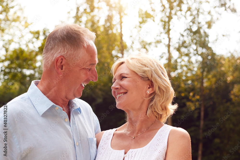 Portrait Of Loving Senior Couple In Garden At Home Together Portrait Of Loving Senior Couple In Garden At Home Together