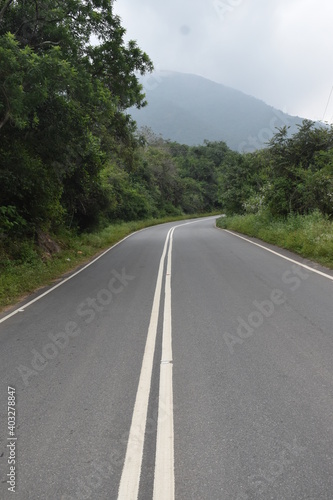 Anaimalai Hills, INDIA - DECEMBER 21 2020 beautiful portrait view of hill mountain road green forest